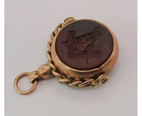 Yellow metal swivel seal fob with intaglio-cut brown stone depicting the Masonic square and compass, 4.9g 