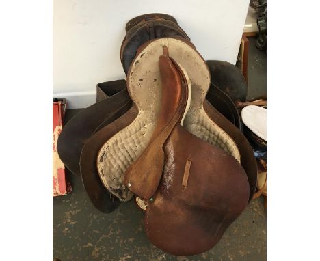 A vintage felt backed racing saddle marked Geo. Parker; together with three English hunting saddles 