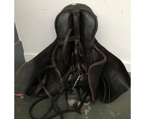 An English cut leather hunting saddle; together with double bridle in serviceable condition 