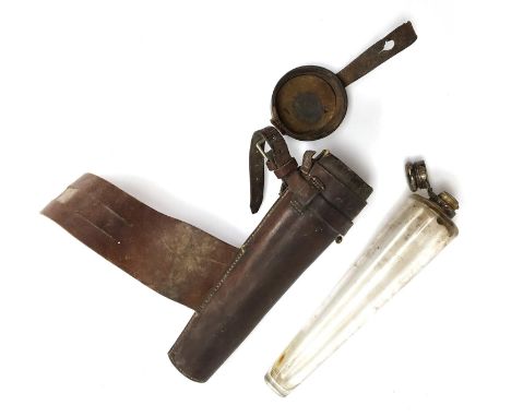 A conical glass hunting flask contained in a leather holder for saddle mounting, the holder 24cmH 