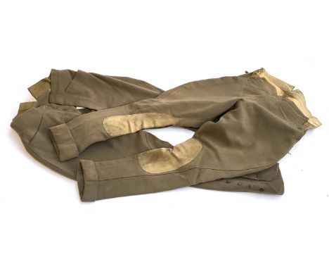 A pair of full cut lady's cavalry twill drab breeches with button fly, cross cut pockets, and side adjustments, button knee a