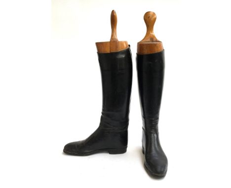 A pair of black lady's hunting boots with wooden trees 