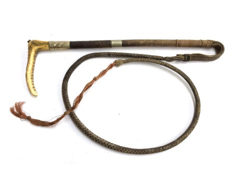 A whale bone and antler hunting whip, with two metal collars and leather thong, the whip 47cmL 