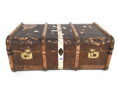A travel trunk with removable tray and wood and brass bracings, side handles and vintage travel stickers, 88cmW 