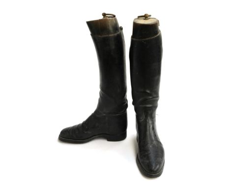 A pair of ladies black hunting boots, approximately size 7, with wooden trees 