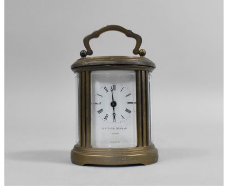 A Miniature Brass Carriage Clock of Oval Form, The White Enamelled Dial Inscribed for Matthew Norman, London, 10.5cms High 