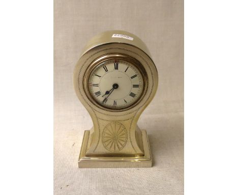 An Edwardian silver cased mantle clock of balloon shape, engraved with a shell medallion, white enamel Roman dial marked indi
