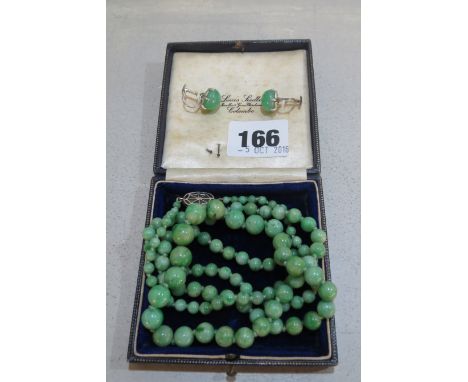 A jade graduated bead single strand necklace with white metal and jade clasp and a pair of silver and jade screw on earrings