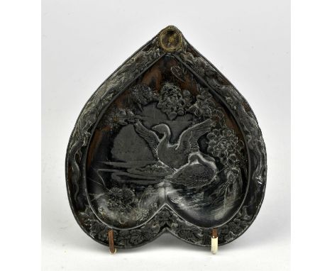 An embossed metal pin tray with compass to top.