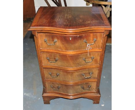A reproduction serpentine front walnut four drawer chest on bracket feet, H. 75cm.