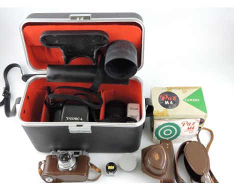 A Yashica FX-D 35mm camera, with an additional 135mm lens, flash and camera case; together with a Pax M4 camera with light me