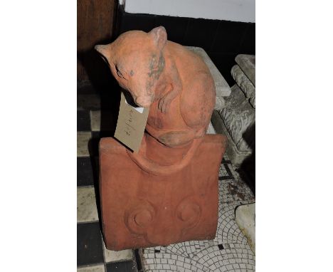 A Victorian style terracotta roof tile moulded with a seated rat.