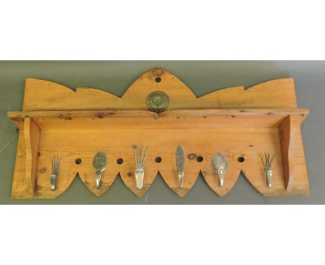 A rustic design pine hanging coat rack, designed by Steve Handley, with shaped shelf, the six hangers formed from vintage pla