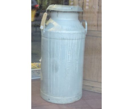 A vintage aluminium milk churn and cover marked                         Cliffords Dairy Ltd (of Teddington), H.70cm.