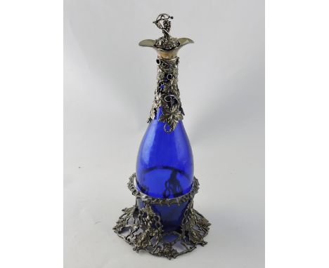 A Victorian style blue glass decanter on stand, with plate mounted vineous neck. H. 34cm.