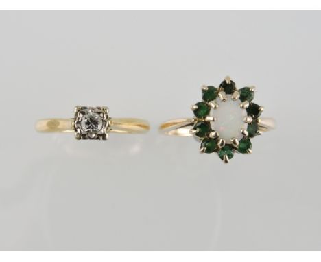 A diamond solitaire ring, the illusion set stone in a 9ct yellow gold band, together with an opal and emerald ring, 4.3g