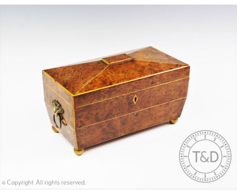 A George III yew wood tea caddy, of sarcophagus form  applied with gilt metal cornucopia ring handles, the interior with two 