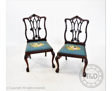 A set of ten Chippendale style mahogany dining chairs, early 20th century, each chair with a shell crest above an interlaced 