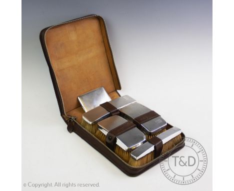 A gentleman's silver backed dressing table set, Barker Brothers Silver Ltd, Birmingham 1935, comprising four brushes, all of 