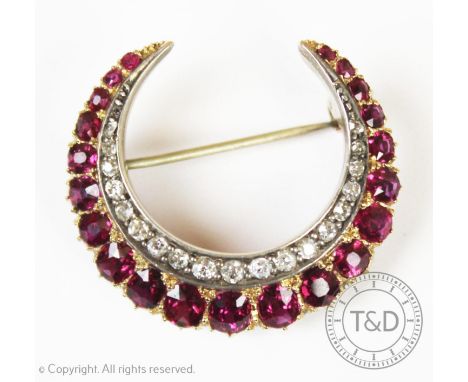 A Victorian diamond and ruby set crescent brooch, designed as a graduated formation of twenty-one rubies claw set in yellow m