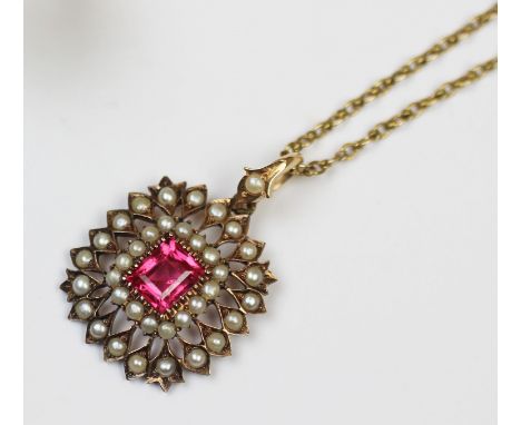 An Edwardian tourmaline and seed pearl set pendant, designed as a claw set step-cut tourmaline, to a surround of thirty-six c