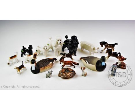 A collection of ceramic animals to include two large and two small Beswick poodles, a Beswick pig, a Beswick foal and two oth