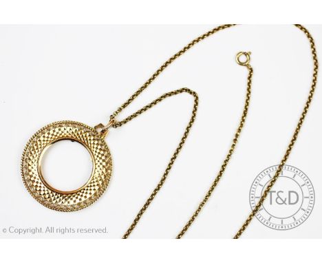 A sovereign pendant mount, with a pierced decoration border, 3.7cm diameter, pendant loop stamped '585', gross weight 6.9gms,