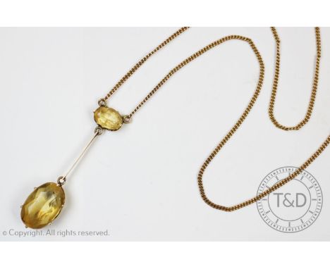 A citrine set drop necklace, the mixed cut oval citrine measuring 10mm x 15mm, claw set to a yellow metal knife edge suspensi