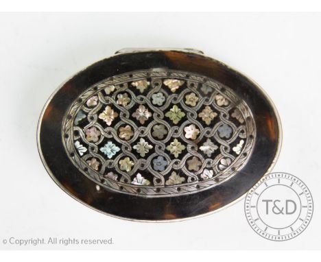 A George III white metal mounted tortoiseshell snuff box, of oval form, with abalone and mother of pearl inlay to the hinged 