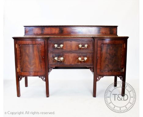 A Chippendale revival mahogany breakfront sideboard, circa 1920, with a dwarf back above two central drawers flanked by bow f