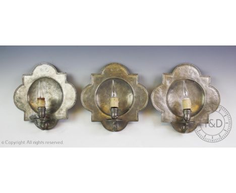 A set of eight Art Nouveau French Etain pewter wall sconces, each centred with chased decoration depicting floral sprays, abo