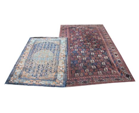 A Caucasian rug, the central medallion on a blue ground within a repeating border, 205cm x 125cm, along with a second rug, wi