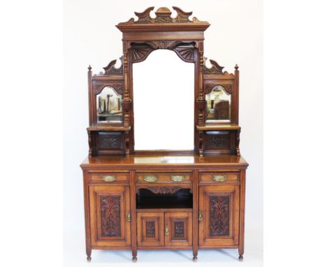 A Victorian walnut mirror back sideboard, having an architectural raised back centred with a bevelled mirror an fan carved up