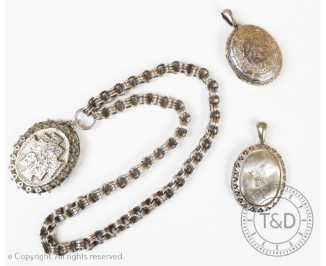 A Victorian silver locket pendant, Birmingham 1886, designed with central floral spray, to a starred border, with attached wh