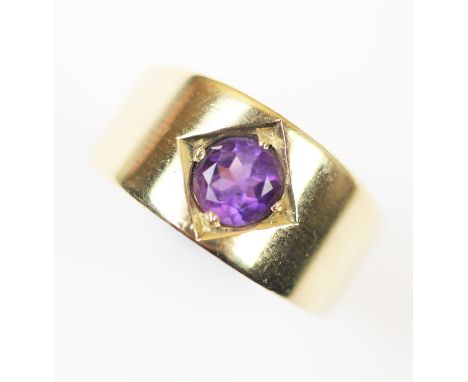 An amethyst set ring, the central round mixed cut amethyst claw set to plain polished yellow metal shank, unmarked, ring size