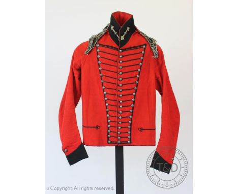 An early 20th century Cheshire Cavalry jacket and associated trousers, the jacket with navy braiding and chain detail to the 