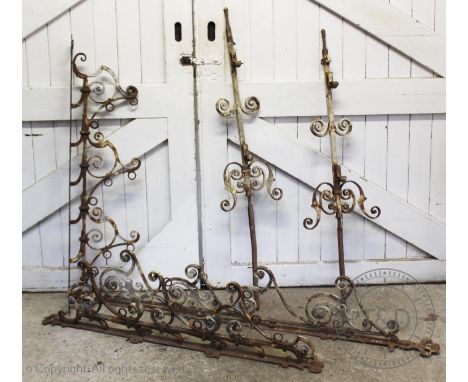 Three wrought iron architectural mounts with a pair of supports, early 20th century, each cast with scroll terminals , possib