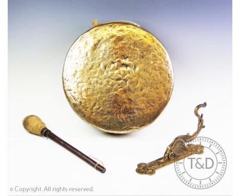 A brass wall mounted dinner gong, 20th century, the circular gong supported on a bracket cast as a mythological bird, 33cm di