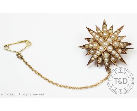 A Victorian seed pearl set starburst brooch, the twelve point star with graduating half seed pearls set to unmarked yellow me