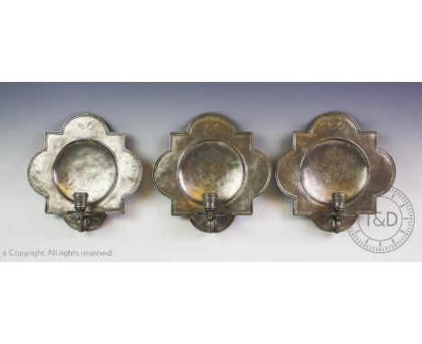 A set of eight Art Nouveau French Etain pewter wall sconces, each centred with chased decoration depicting floral sprays, abo