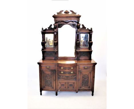 A late Victorian walnut mirror back sideboard, the architectural high back with three mirrors, above the base with an arrange
