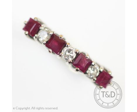 A ruby and diamond seven stone half eternity ring, the four square cut rubies interspersed with three brilliant cut diamonds,