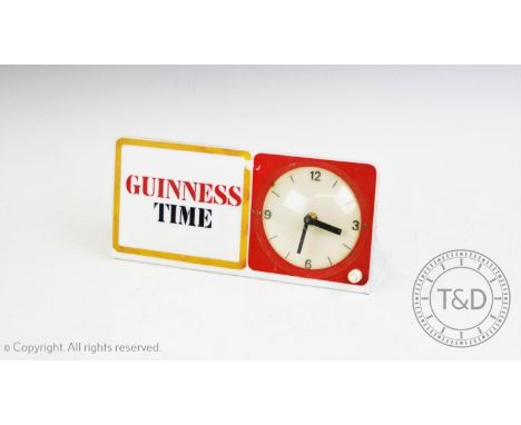 A 1970's 'Guinness Time' electric advertising clock, of easel form with rear back light, 10cm dial and electric movement, 31c
