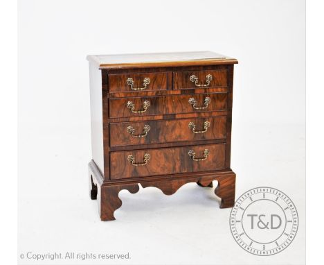 A marquetry inlaid burr walnut bachelors type chest, possibly converted from a piano, with two short and three long drawers, 