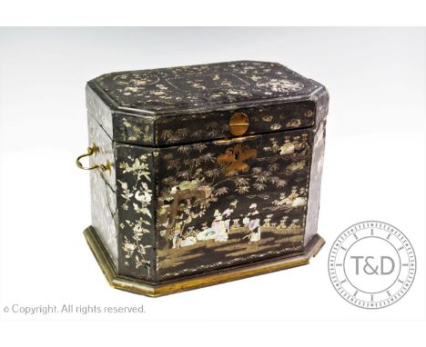 A Victorian papier mache tea caddy, the rectangular box with canted corners applied with side brass swing handles,the case in