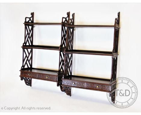 A pair of Chippendale style mahogany wall shelves, 20th century, each wall shelf with three graduated shelves and a pair of b