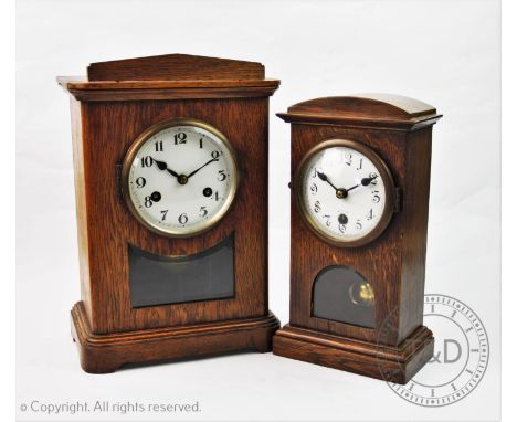 An early 20th century oak cased bracket clock, the rectangular case enclosing a 12cm white enamel dial above a glazed viewing