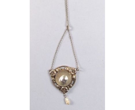 An Arts & Crafts silver and blister pearl pendant with floral decoration and pearl drop