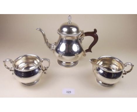 A silver three piece tea service with beaded border - Birmingham 1965, 971g