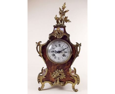 A  French tortoiseshell bombe form mantel clock with scrollwork gilt metal mounts